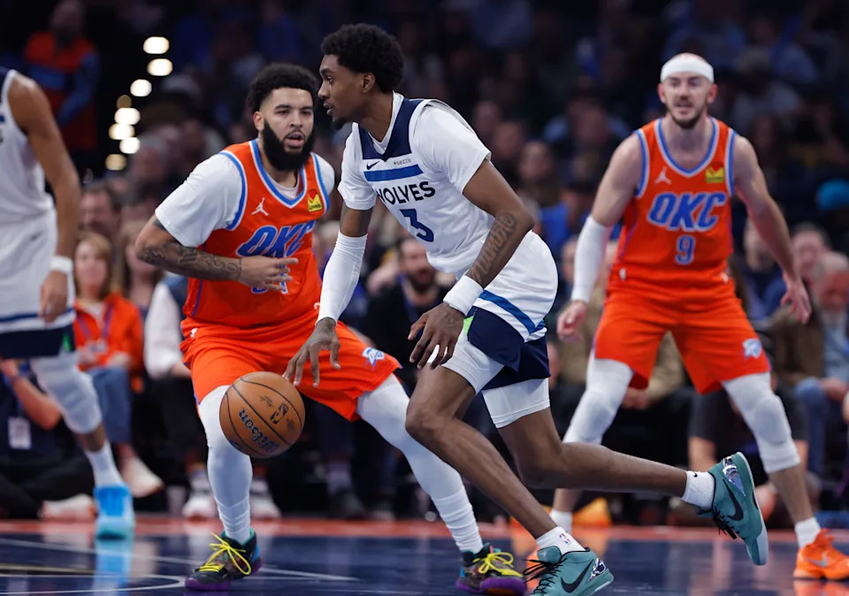 Nov 26, 2025; Oklahoma City, Oklahoma, USA; Minnesota Timberwolves forward Jaden McDaniels (3) moves around Oklahoma City Thunder guard Kenrich Williams (34) during the second quarter at Paycom Center. Mandatory Credit: Alonzo Adams-Imagn Images