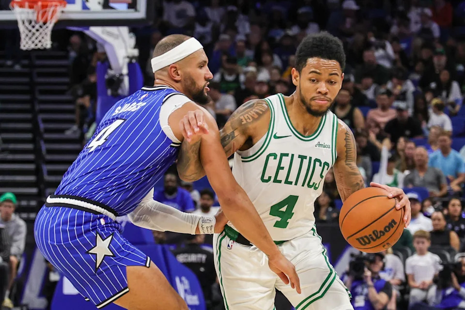 Nov 9, 2025; Orlando, Florida, USA; Boston Celtics guard Anfernee Simons (4) drives past Orlando Magic guard Jalen Suggs (4) during the second quarter at Kia Center. Mandatory Credit: Mike Watters-Imagn Images