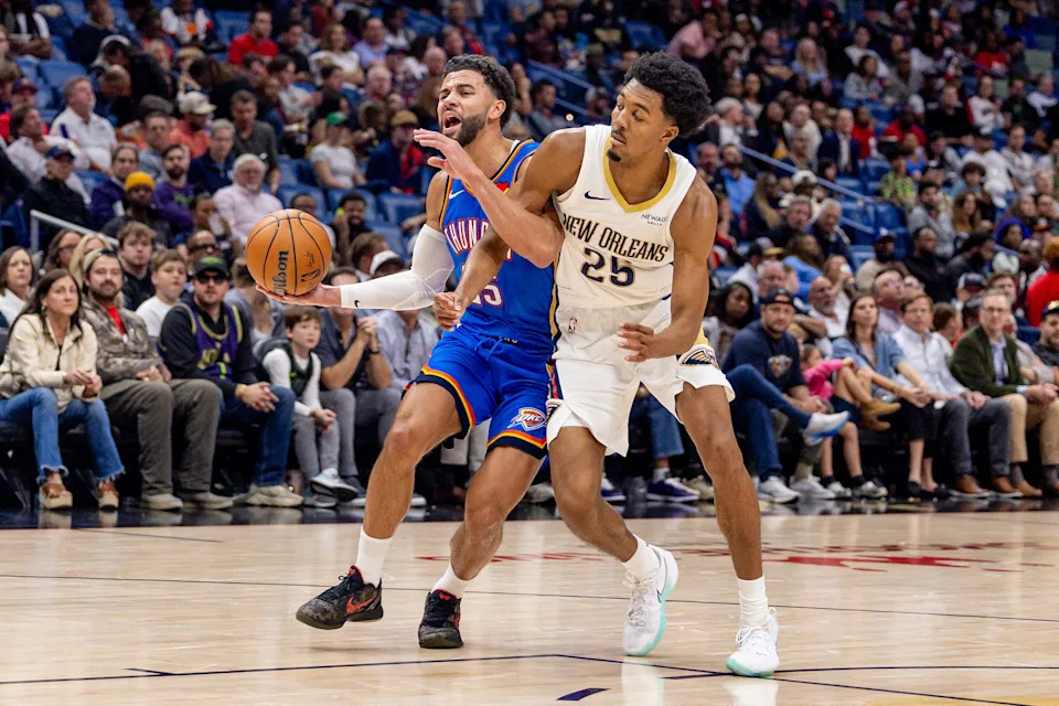 Nov 17, 2025; New Orleans, Louisiana, USA; Oklahoma City Thunder guard Ajay Mitchell (25) dribbles against New Orleans Pelicans forward Trey Murphy III (25) during the first half at Smoothie King Center. Mandatory Credit: Stephen Lew-Imagn Images