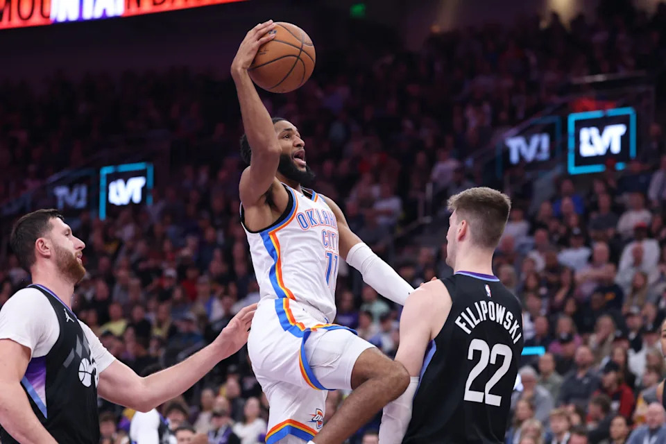 Nov 21, 2025; Salt Lake City, Utah, USA; Oklahoma City Thunder guard Isaiah Joe (11) goes to the basket against Utah Jazz center Jusuf Nurkic (30) and forward Kyle Filipowski (22) during the first half at Delta Center. Mandatory Credit: Rob Gray-Imagn Images