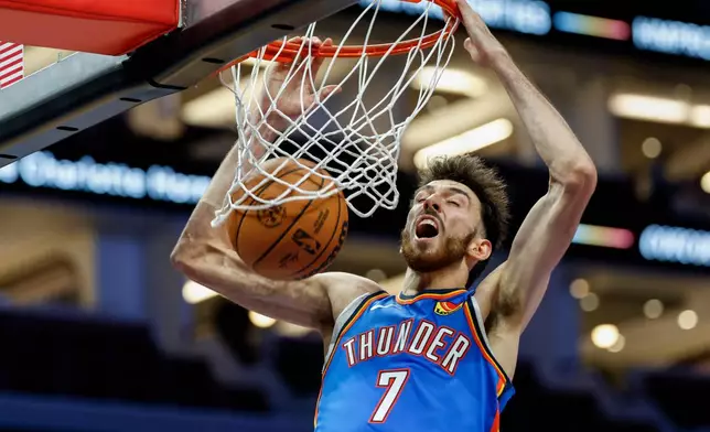 Oklahoma City Thunder center Chet Holmgren dunks against the Charlotte Hornets during the second half of an NBA basketball game in Charlotte, N.C., Saturday, Nov. 15, 2025. (AP Photo/Nell Redmond)