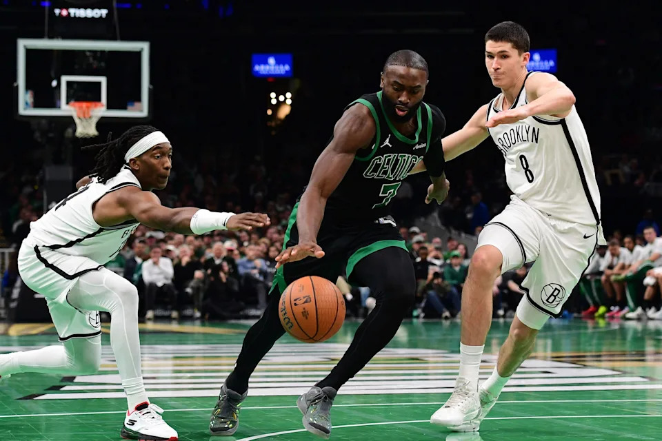 Nov 21, 2025; Boston, Massachusetts, USA; Boston Celtics guard Jaylen Brown (7) controls the ball between Brooklyn Nets guard Terance Mann (14) and guard Egor Demin (8) during the second half at TD Garden. Mandatory Credit: Bob DeChiara-Imagn Images