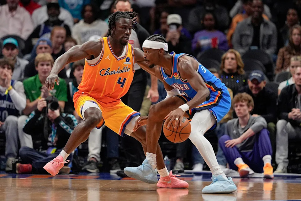 Nov 15, 2025; Charlotte, North Carolina, USA; Charlotte Hornets guard Sion James (4) defends against Oklahoma City Thunder guard Shai Gilgeous-Alexander (2) during the first half at Spectrum Center. Mandatory Credit: Jim Dedmon-Imagn Images