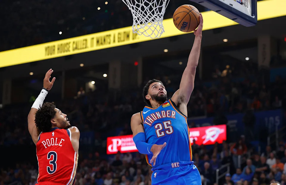 Nov 2, 2025; Oklahoma City, Oklahoma, USA; Oklahoma City Thunder guard Ajay Mitchell (25) goes to the basket beside New Orleans Pelicans guard Jordan Poole (3) during the second quarter at Paycom Center. Mandatory Credit: Alonzo Adams-Imagn Images