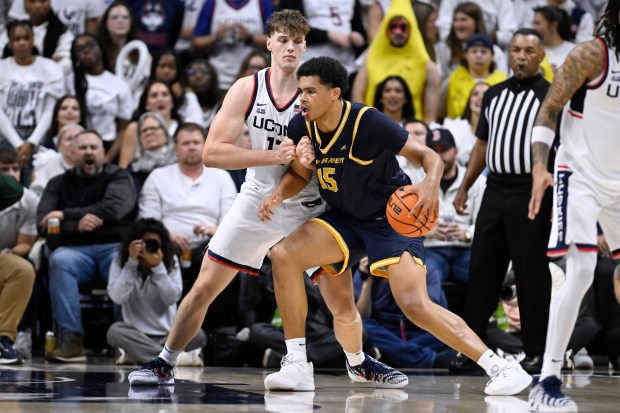 UConn center Eric Reibe, left, guards New Haven forward Andre Pasha, who proved a tough matchup for the Huskies' frontcourt. (AP Photo/Jessica Hill)