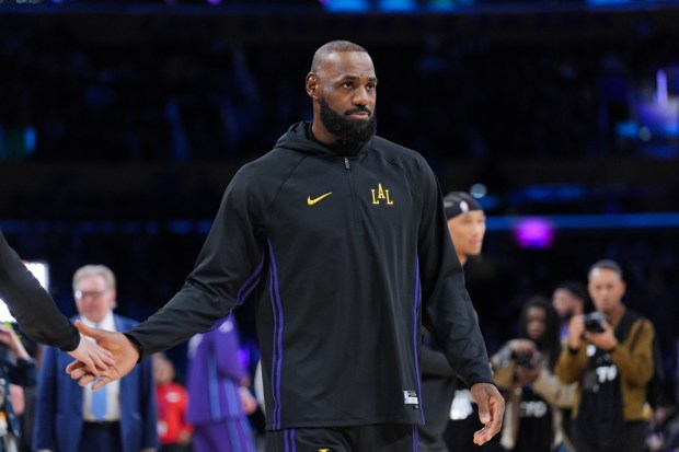 Lakers star LeBron James warms up before their game against...