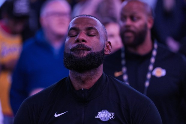 Lakers star LeBron James sits on the bench during player...