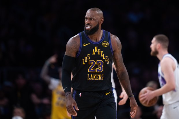 Lakers star LeBron James walks on the court during the...