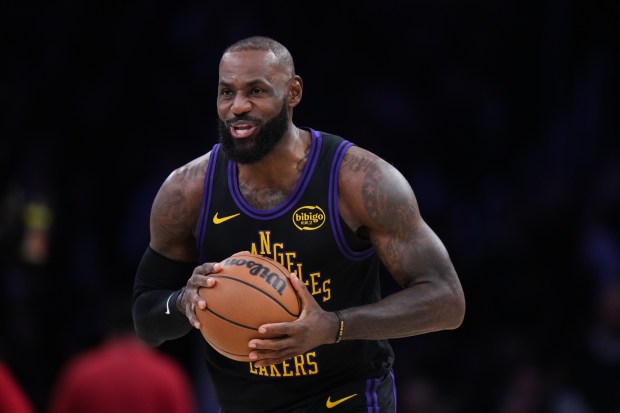Lakers star LeBron James holds the ball before the tip-off...
