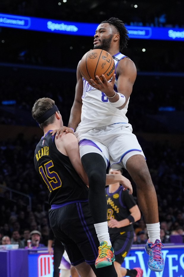 Utah Jazz guard Isaiah Collier, right, fouls Lakers guard Austin...