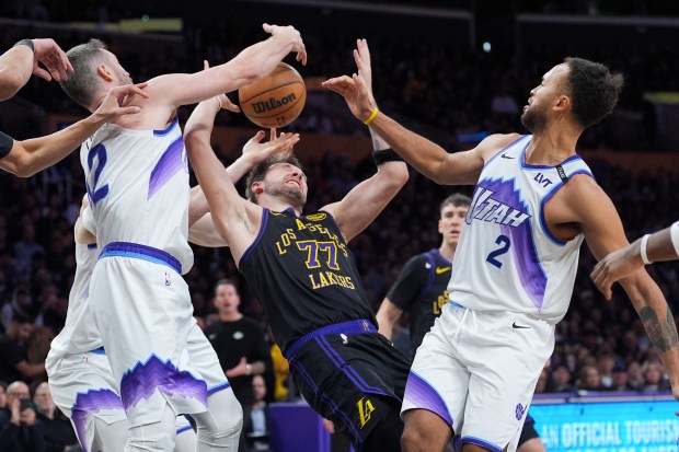 Lakers guard Luka Doncic (77) battles for a rebound with...