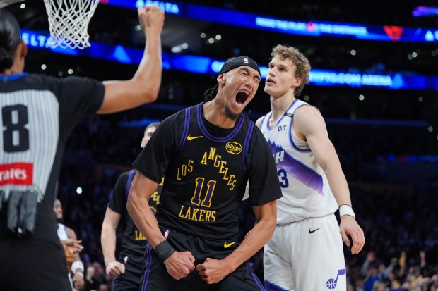 Lakers center Jaxson Hayes celebrates after scoring and drawing a...
