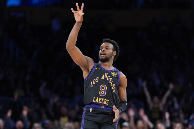 Lakers guard Bronny James reacts after making a 3-point shot...