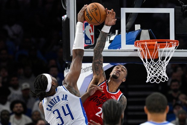 Clippers forward John Collins blocks a shot by Orlando Magic...