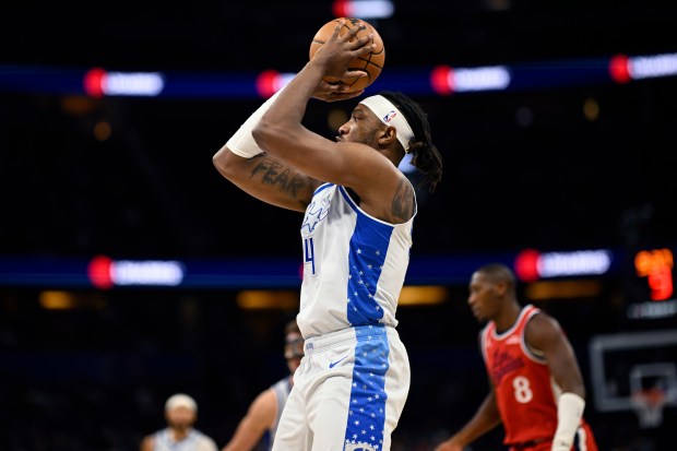 Orlando Magic center Wendell Carter Jr., left, goes up to...