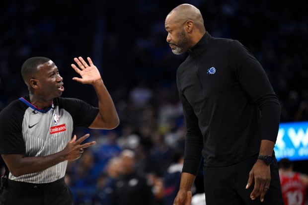 Orlando Magic head coach Jamahl Mosley, right, gets an explanation...