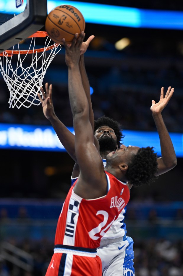 Orlando Magic forward Jonathan Isaac, rear, blocks a shot by...