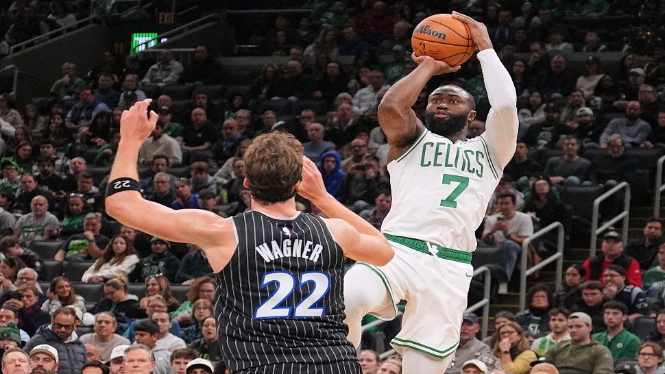 Boston Celtics guard Jaylen Brown (7) takes a shot over Orlando Magic forward Franz Wagner (22) during the first half of an NBA basketball game, Sunday, Nov. 23, 2025, in Boston. (AP Photo/Charles Krupa)