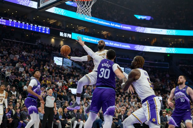 Lakers forward LeBron James, center top, drives to the basket...