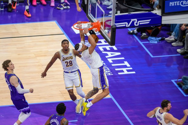 Lakers center Jaxson Hayes, center, dunks the ball during the...