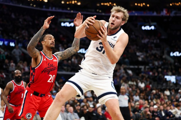 Memphis Grizzlies center Jock Landale, right, rebounds the ball against...
