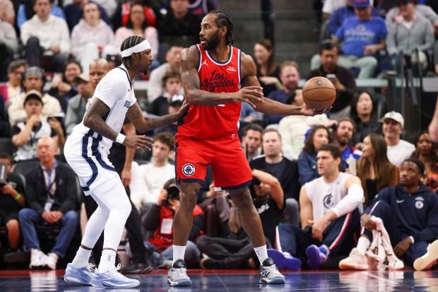 Clippers star Kawhi Leonard holds the ball as Memphis Grizzlies...