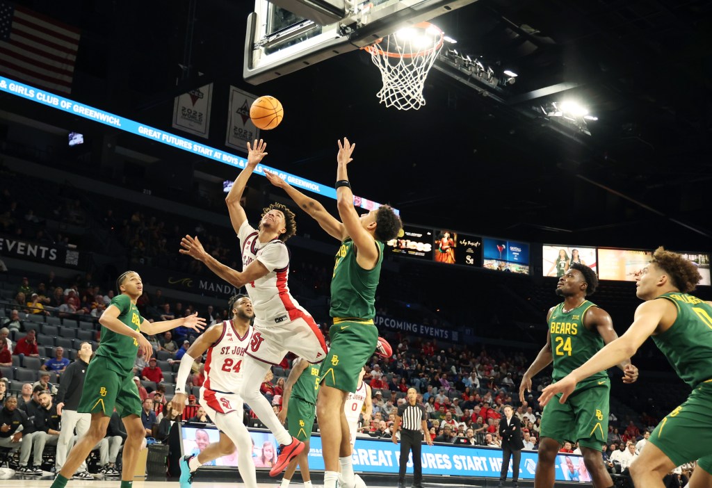 St. John's guard Oziyah Sellers (4) goes for a shot around Baylor guard Michael Rataj (12) during the first half of an NCAA college basketball game Tuesday, Nov. 25, 2025, in Las Vegas. 