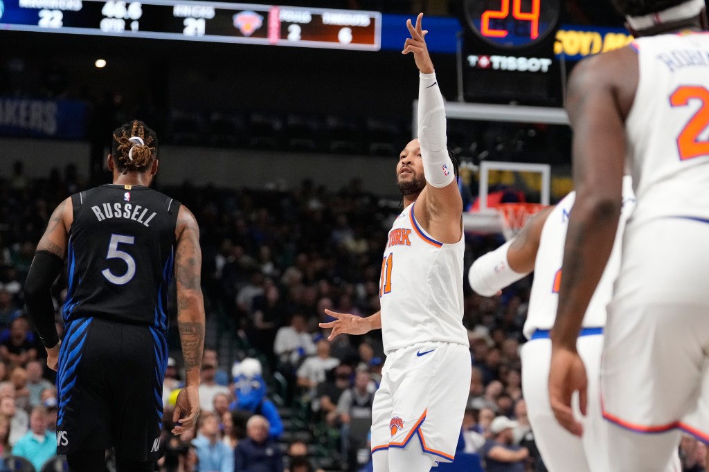 New York Knicks guard Jalen Brunson (11) reacts after scoring a three pointer against Dallas Mavericks guard D'Angelo Russell (5) in the first half of an NBA basketball game Wednesday, Nov. 19, 2025, in Dallas.