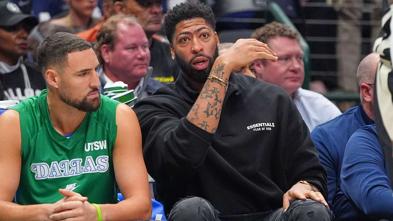 Dallas Mavericks forward Anthony Davis, right, sits on the bench with teammate Dallas Klay Thompson during the first half of an NBA basketball game against the Milwaukee Bucks in Dallas, Monday, Nov. 10, 2025. (AP Photo/LM Otero)