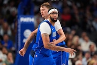 Dallas Mavericks' Anthony Davis, front, and Cooper Flagg (32) jog downcourt during an NBA...