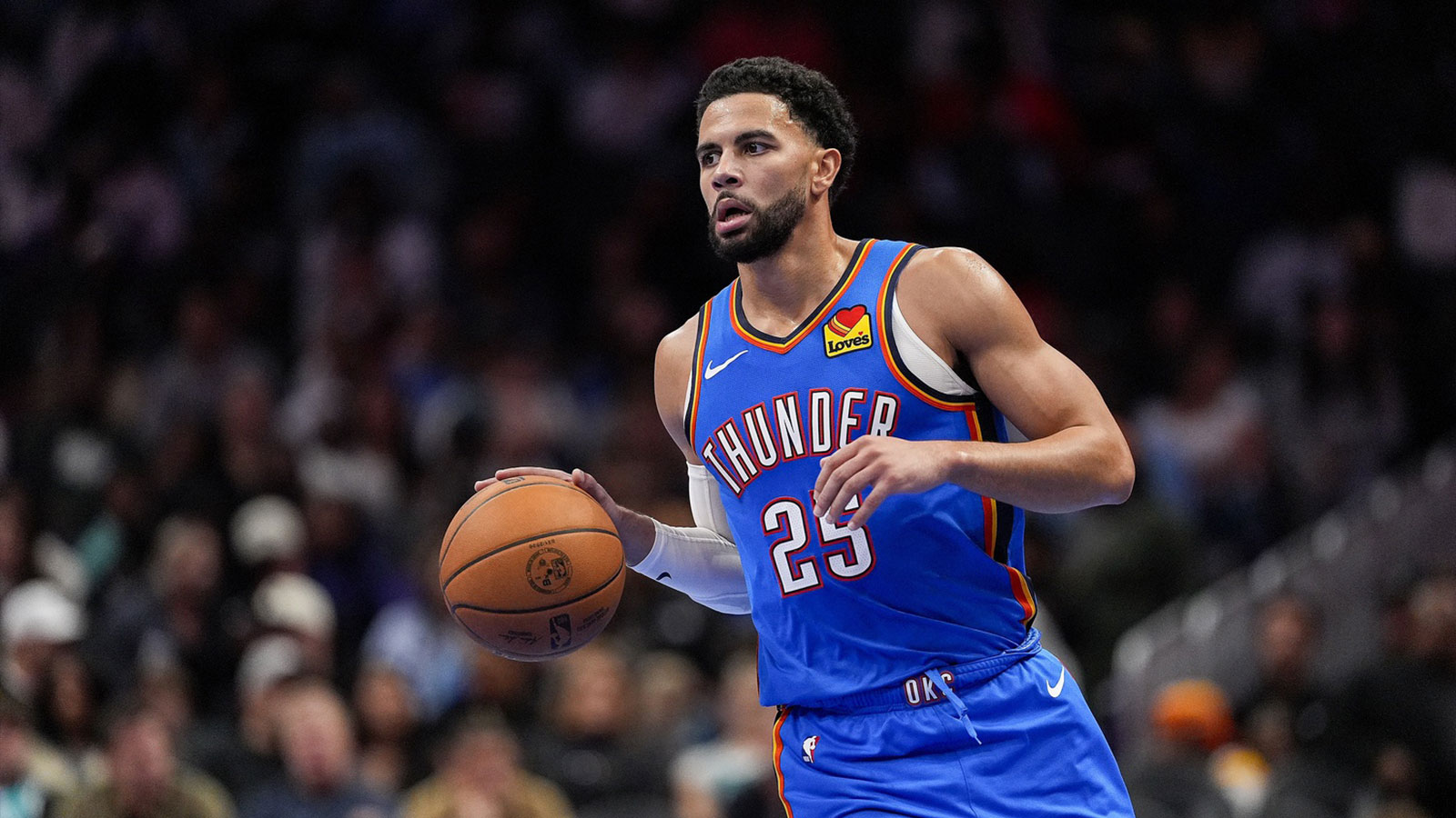 Oklahoma City Thunder guard Ajay Mitchell (25) brings the ball up court against the Charlotte Hornets during the second half at Spectrum Center. 