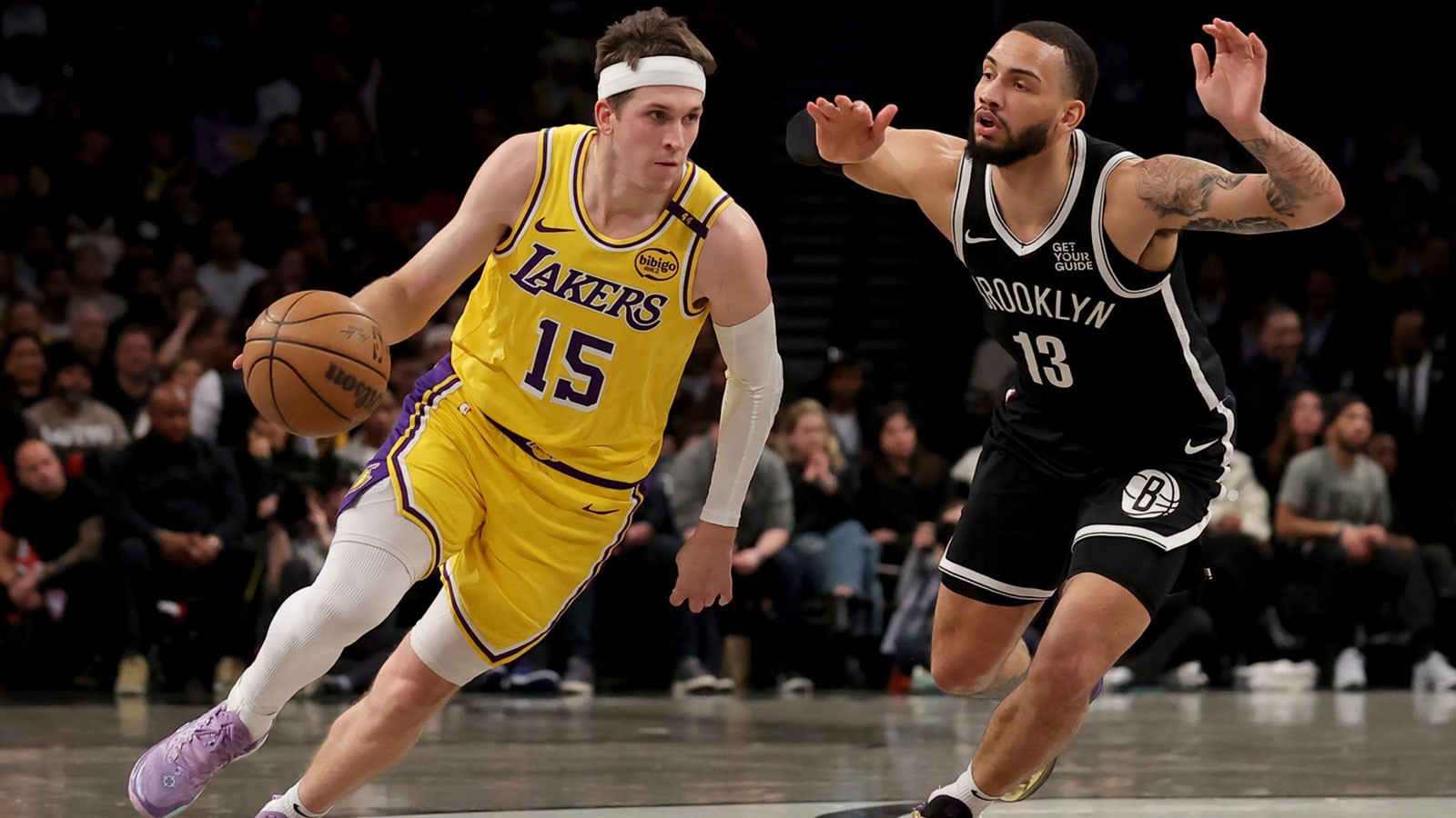 Los Angeles Lakers guard Austin Reaves (15) controls the ball against Brooklyn Nets guard Tyrese Martin (13) during the first quarter at Barclays Center.