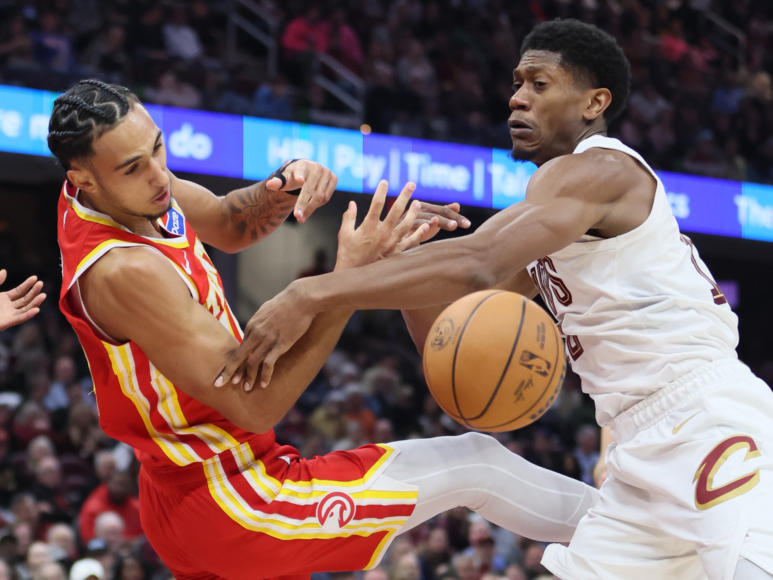 Cleveland Cavaliers forward De'Andre Hunter (R) and Atlanta Hawks forward Zaccharie Risacher battle for possession of a rebound in the first half at Rocket Arena. 