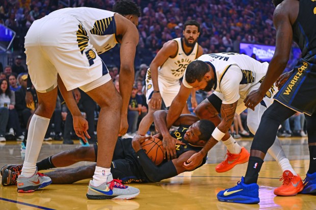 Indiana Pacers' Cody Martin (11) battles for a loose ball with Golden State Warriors' Jonathan Kuminga (1) in the first quarter of their NBA game at Chase Center in San Francisco, Calif., on Sunday, Nov. 9, 2025. (Jose Carlos Fajardo/Bay Area News Group)