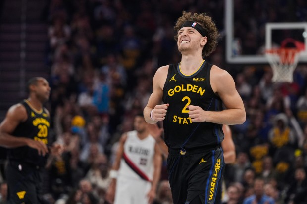Golden State Warriors guard Brandin Podziemski reacts after making a 3-point basket during the first half of an NBA Cup basketball game against the Portland Trail Blazers, Friday, Nov. 21, 2025, in San Francisco. (AP Photo/Godofredo A. Vásquez)