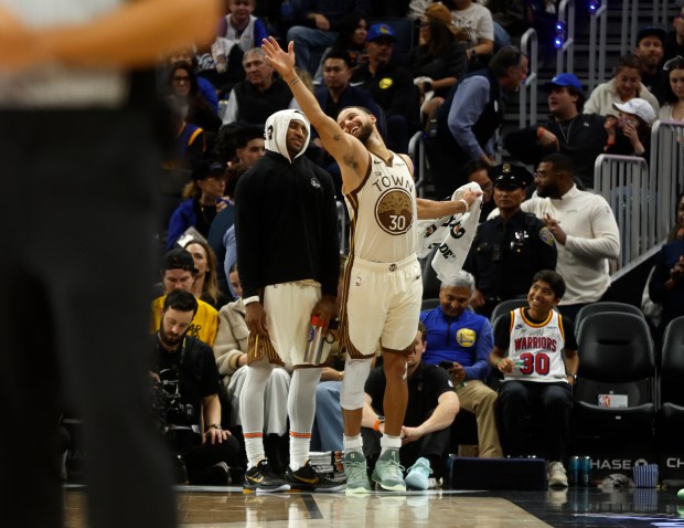 Golden State Warriors' Stephen Curry (30) chats with Golden State...