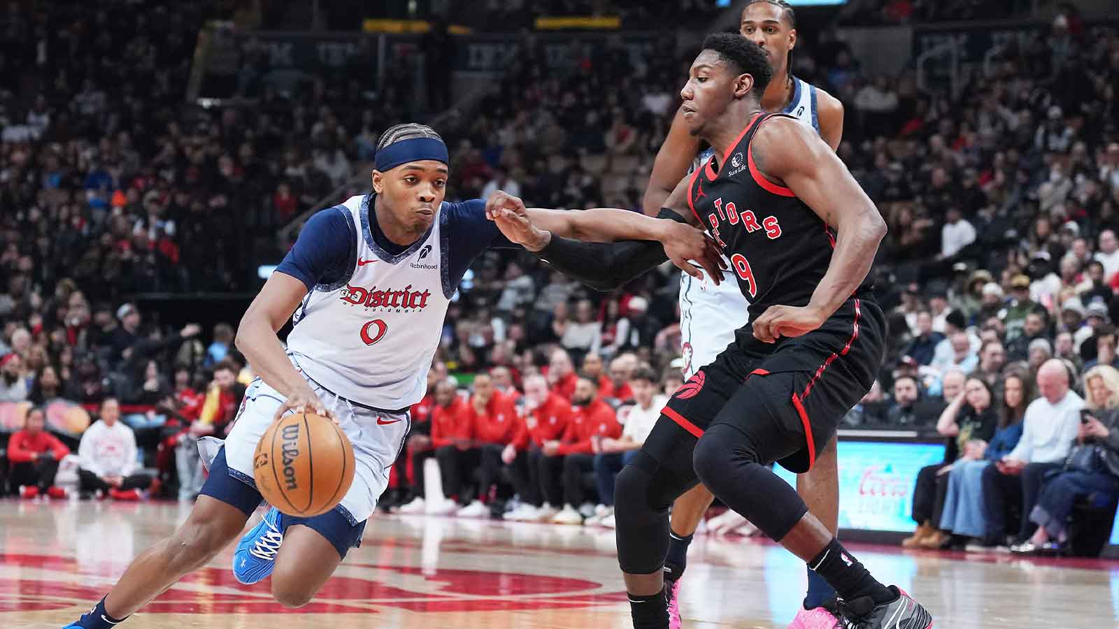 Washington Wizards guard Bilal Coulibaly (0) controls the ball as Toronto Raptors guard RJ Barrett (9) tries to defend during the first quarter at Scotiabank Arena.