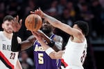 Portland Trail Blazers forward Toumani Camara (33) steals the ball from Los Angeles Lakers center Deandre Ayton (5) during the second half of an NBA basketball game Monday, Nov. 3, 2025, in Portland, Ore.