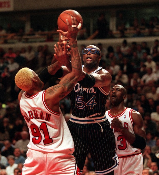 Orlando's Horace Grant is sandwiched between the Bulls' Dennis Rodman...