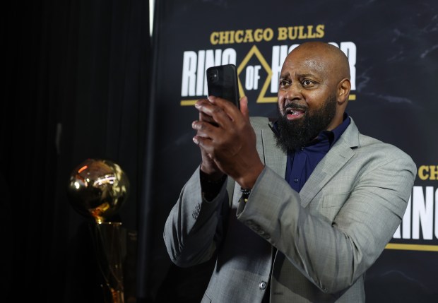 Horace Grant takes a picture of Bulls photographer Bill Smith...