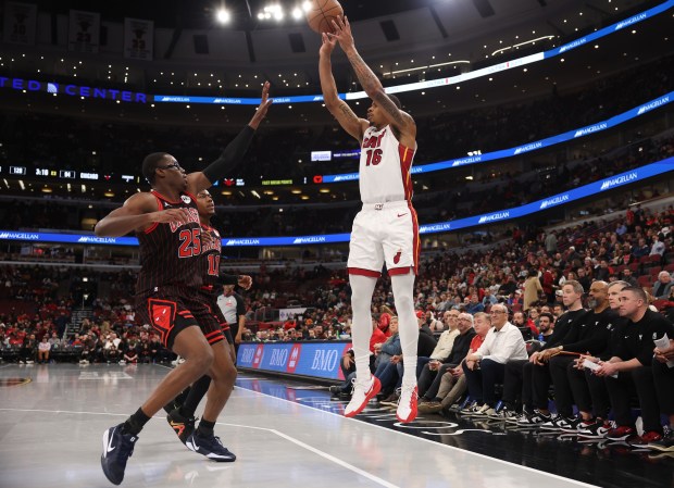 Heat forward Keshad Johnson (16) releases a successful 3-pointer as Bulls forward Jalen Smith (25) and guard Ayo Dosunmu (11) are late to defend in the fourth quarter at the United Center on Nov. 21, 2025, in Chicago. (John J. Kim/Chicago Tribune)