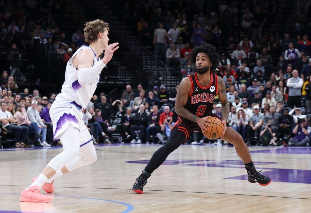 Bulls guard Coby White steps back to shoot against Jazz forward Lauri Markkanen during overtime Sunday, Nov. 16, 2025, in Salt Lake City. (AP Photo/Rob Gray)