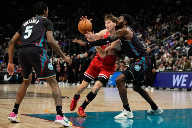 Bulls forward Matas Buzelis drives against Pistons forward Paul Reed, right, and guard Ronald Holland II during the second half Wednesday, Nov. 12, 2025, in Detroit. (AP Photo/Ryan Sun)