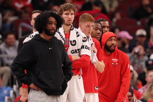 Injured Bulls guard Coby White, left, looks on from the bench during a game against the 76ers on Tuesday, Nov. 4, 2025, at the United Center. (Michael Reaves/Getty Images)