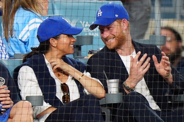 Prince Harry, right, and Meghan Markle, Duke and Duchess of Sussex, sit during the eighth inning in Game 4 of the World Series between the Dodgers and the Blue Jays on Tuesday, Oct. 28, 2025, in Los Angeles. (Frank Gunn/The Canadian Press via AP)