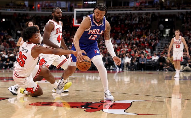Chicago Bulls forward/guard Isaac Okoro (left) tries to steal the ball from Philadelphia 76ers guard/forward Trendon Watford (12) in the first half of a game at the United Center in Chicago on Nov. 4, 2025. (Chris Sweda/Chicago Tribune)