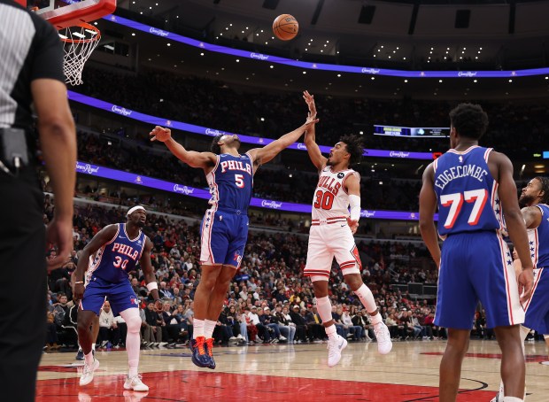 Chicago Bulls guard Tre Jones (30) shoots over Philadelphia 76ers guard Quentin Grimes (5) in the first half of a game at the United Center in Chicago on Nov. 4, 2025. (Chris Sweda/Chicago Tribune)