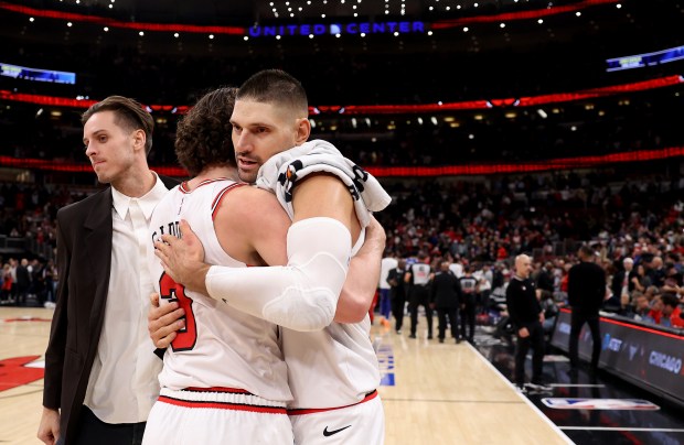 Chicago Bulls guard Josh Giddey and center Nikola Vučević (9) celebrate after a victory over the Philadelphia 76ers at the United Center in Chicago on Nov. 4, 2025. (Chris Sweda/Chicago Tribune)