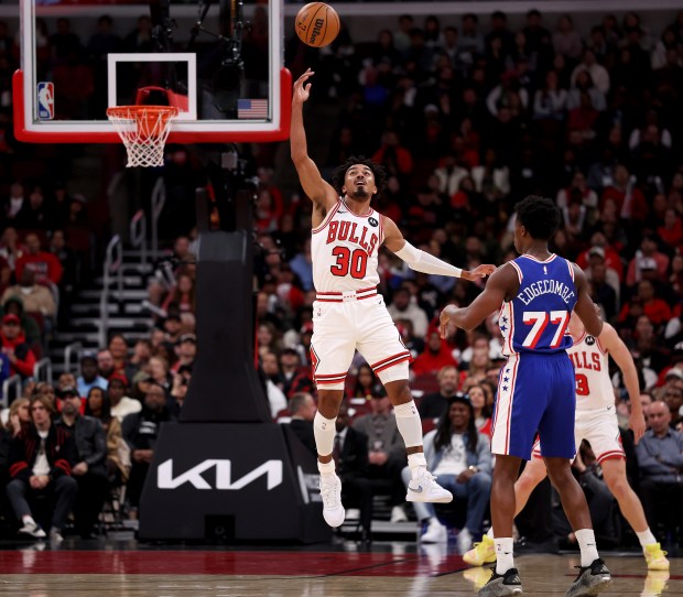 Chicago Bulls guard Tre Jones (30) tips a pass from Philadelphia 76ers guard Vj Edgecombe (77) in the first half of a game at the United Center in Chicago on Nov. 4, 2025. (Chris Sweda/Chicago Tribune)