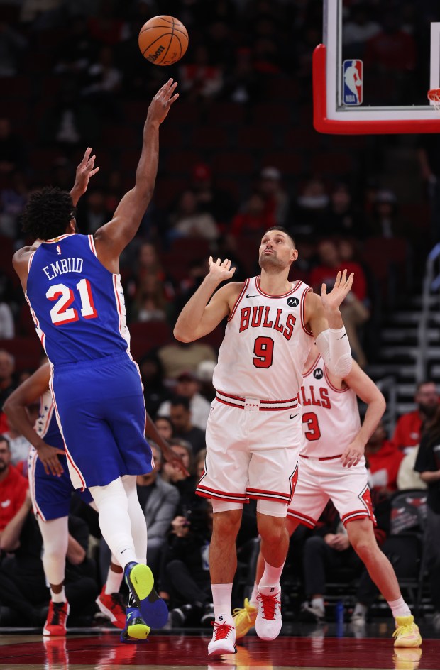 Philadelphia 76ers center/forward Joel Embiid (21) shoots over Chicago Bulls center Nikola Vučević (9) in the first half of a game at the United Center in Chicago on Nov. 4, 2025. (Chris Sweda/Chicago Tribune)